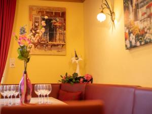 a table with two wine glasses and flowers on it at Winter Chalet Kaprun in Kaprun