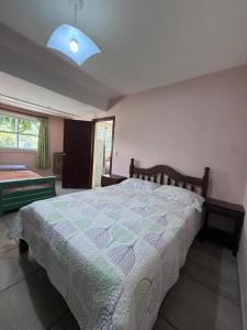 a bedroom with a large bed and a blue light at CASA EN VALERIA DEL MAR Y PLAYA in Valeria del Mar