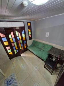 a room with a bed and stained glass windows at Kitnets com AR Condicionado na Praia in Salvador