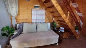 a room with a couch in a attic at Secluded holiday house Kali, Ugljan - 23713 in Kali