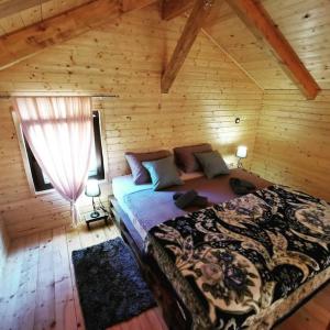 a bedroom with a bed in a log cabin at Secluded holiday house Kali, Ugljan - 23713 in Kali