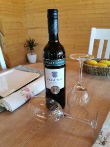 a bottle of wine and a glass on a table at Secluded holiday house Kali, Ugljan - 23713 in Kali