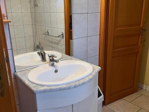 a bathroom with a white sink and a shower at Gîte de plain-pied avec terrasse, proche port et station thermale, idéal pour familles - FR-1-589-24 in Fontenoy-le-Château +6 photos