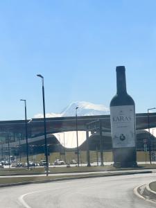 a bottle of wine sitting on the side of a road at Prime Hotel And Rental Cars 24 & 7 in Yerevan Parakar