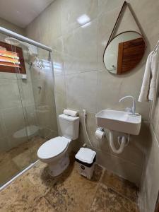 a bathroom with a toilet and a sink and a shower at Butterfly House in Flecheiras +13 photos