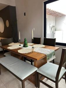 a dining room table with a christmas tree on it at Encanto Taxqueño in Taxco de Alarcón
