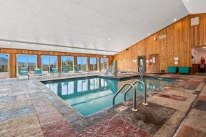 a large swimming pool in a large building with windows at Above The Clouds in Gatlinburg