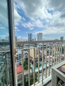 a balcony with a view of a city at LJ's escape 2BR COAST Residences in Manila