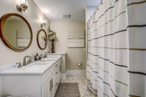 a bathroom with two sinks and a mirror at Elegant Mansion on Park in Historic Avondale in Jacksonville +69 photos
