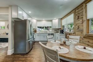 a kitchen with a table and a refrigerator at Elegant Mansion on Park in Historic Avondale in Jacksonville