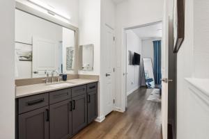 a bathroom with a sink and a large mirror at Frisco Business Class, Modern Executive Suite in Frisco +29 photos