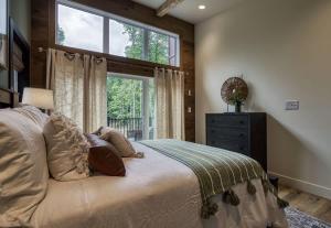 a bedroom with a large bed and a window at Arise in the Glades in Gatlinburg