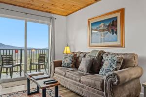 a living room with a couch and a table at Whispering Woods Condo in Gatlinburg