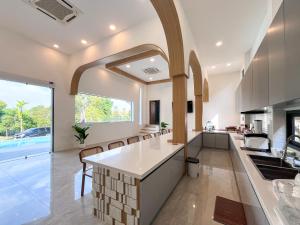 an open kitchen with a large window and a kitchen island at Celine House by Craft Village in Chaweng