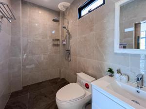 a bathroom with a toilet and a sink and a shower at Celine House by Craft Village in Chaweng +22 photos