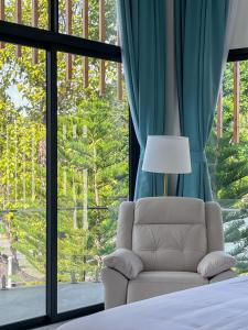 a bedroom with a couch and a large window at Celine House by Craft Village in Chaweng