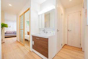 a bathroom with a sink and a mirror at Mori hotel Akihabara 2 in Tokyo +77 photos
