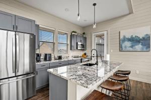 a kitchen with a large counter and a refrigerator at Mountain Lake Escape in Dandridge