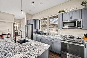 a kitchen with stainless steel appliances and a marble counter top at Mountain Lake Escape in Dandridge +42 photos