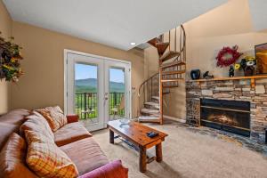 a living room with a couch and a fireplace at Rocky Top Oasis in Gatlinburg