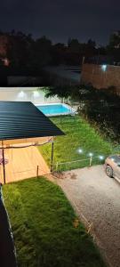 a car parked next to a swimming pool at night at Clover Hostel in Mendoza