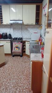 a kitchen with white cabinets and a stove top oven at morada da felicidade in São Gabriel +5 photos