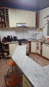 a kitchen with white cabinets and a counter top at morada da felicidade in São Gabriel