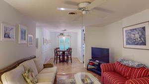 a living room with a couch and a tv at BEACHBREAK apts in Jekyll Island
