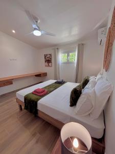 a bedroom with a large bed with a ceiling at La Villa Harmonie in Sainte-Luce +46 photos