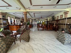 a lobby of a hotel with chairs and tables at Ho Phong Hotel in Phan Rang–Tháp Chàm