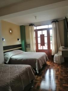 Postel nebo postele na pokoji v ubytování Hotel Incas Suite, con Aguas Termomedicinales