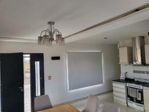 a kitchen with a table and chairs and a window at Residencial Las Heras in Las Heras +5 photos