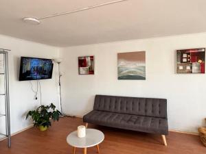 a living room with a couch and a table at Cómodo Departamento en Puerto Montt in Puerto Montt