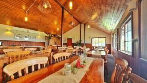 a dining room with wooden tables and chairs at Baudins Accommodation in Naracoopa