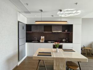 a kitchen with a table and a dining room at Somerset Xuhui Riverside Shanghai serviced apartments in Shanghai +16 photos
