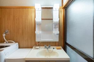 a small kitchen with a sink and a microwave at Kujukuri Town Katakai Detached House in Katakai +29 photos