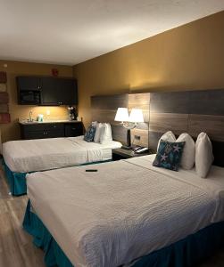 a hotel room with two beds and a kitchen at Ocean View 2 Queen Studio at Landmark Resort in Myrtle Beach +9 photos
