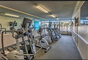 a gym with several treadmills and elliptical machines at Ocean View 2 Queen Studio at Landmark Resort in Myrtle Beach