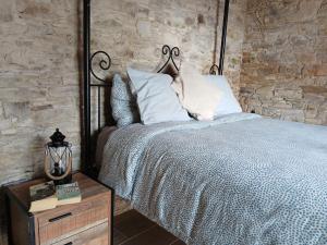 a bedroom with a bed and a brick wall at Mountain View Oasis in Skarinou