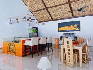 a kitchen and dining room with a table and chairs at Villa Asyik in Seminyak