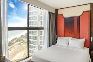Ein Bett oder Betten in einem Zimmer der Unterkunft Apec Beach Mui Ne Resort