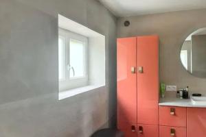 a bathroom with a red cabinet and a sink at Maison normande apaisante à Hermival-les-Vaux avec sauna in Hermival-les-Vaux +29 photos
