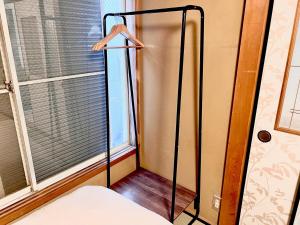 a room with a window and a white refrigerator at 千住4丁目2階 日本の和のお部屋スカイツリー9分秋葉原10分浅草12分 in Tokyo