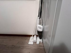 a pair of vacuum cleaners sitting next to a refrigerator at 千住4丁目2階 日本の和のお部屋スカイツリー9分秋葉原10分浅草12分 in Tokyo