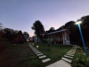 a house with a street light in the yard at Phu Aunna in Ko Phayam