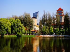 a view of a river with trees and buildings at Jinjiang Inn Kunming Changshui Airport in Kunming