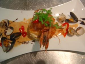 a plate of food with shrimp and mussels on it at Logis Hôtel Les 3B in Nouilhan