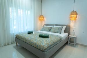 Postel nebo postele na pokoji v ubytování Utopia Varkala - Boutique stay in Odayam rice fields
