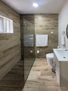 a bathroom with a shower and a toilet and a sink at La Isla Royal - Fisura Eterea in Miches