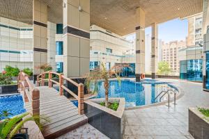 a swimming pool in the middle of a building at Cozy 1 Br Apartment In Axis 2 Residence Dso in Dubai